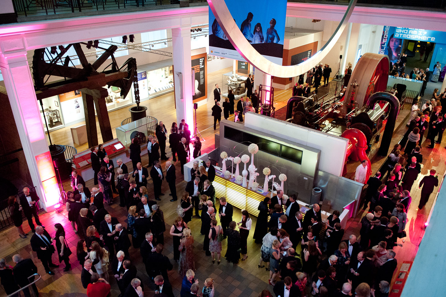 Evening event guests mingle in the Energy Hall