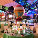 An evening dinner in the Flight gallery with decorative hot air balloons above the tables