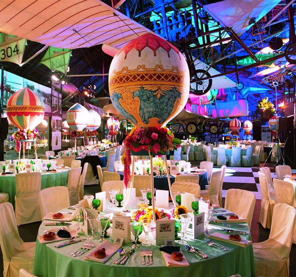 An evening dinner in the Flight gallery with decorative hot air balloons above the tables