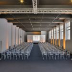 Event space with two aisles of silver chairs