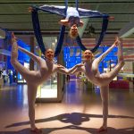 Acrobatic dancers pose in the Who Am I? gallery