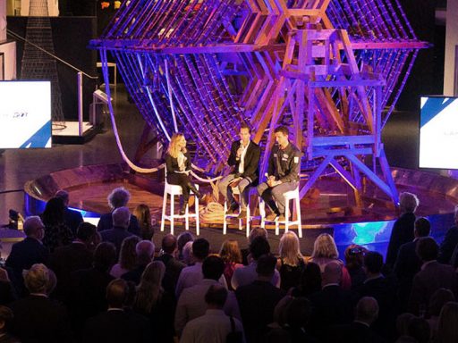 Land Rover BAR event, three guests on stage in front of the aerial tuning inductor in the Information Age gallery