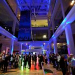 Evening event guests mingle in the Energy Hall